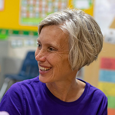 Preschool teacher Dawn Baker smiling at her student.