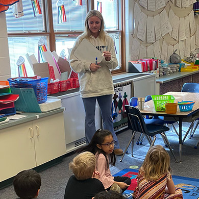 HCHS Spanish Intern Kayla teaching a group of Spanish Immersion kindergartners.