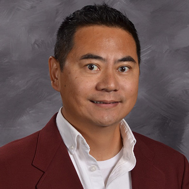 Alex Zhou smiling at the camera