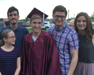 Five Jackson kids at HC graduation all smiling at the camera