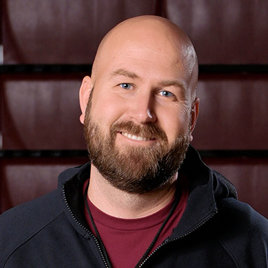 Girls JV basketball coach smiling at the camera