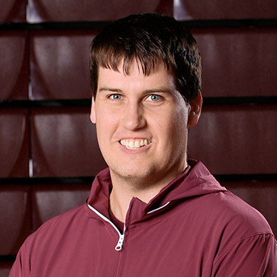 Freshmen girls basketball coach smiling at the camera