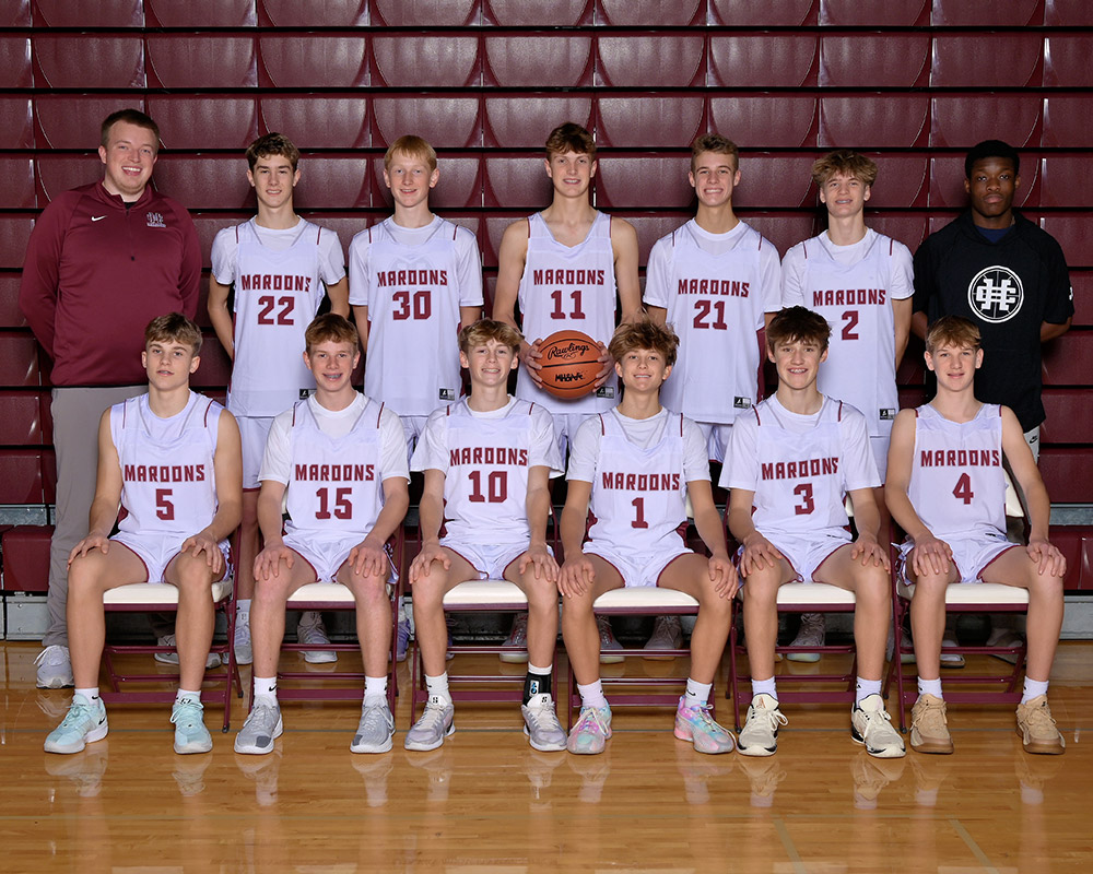 freshmen boys basketball team smiling at the camera