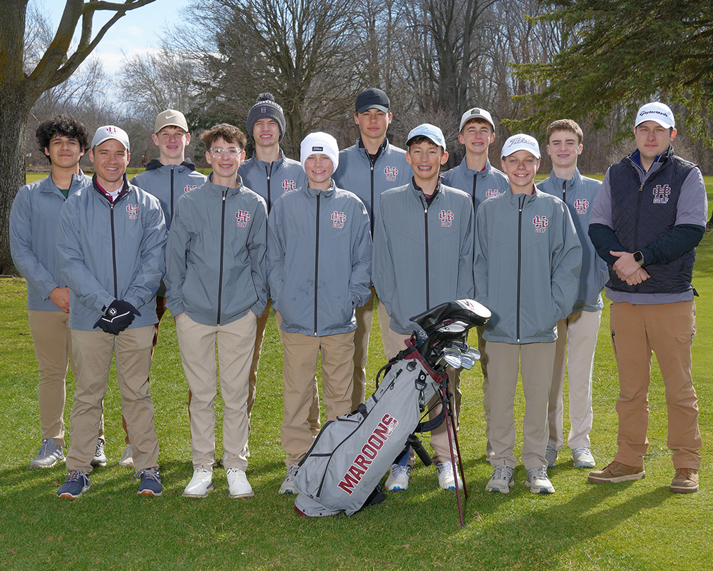 Boys JV golf team looking at the camera, standing outside